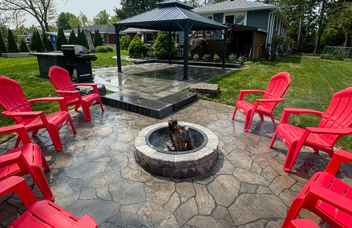VanKuikConstruction-2024-backyard-patio-with-fire-pit One of Van Kuik Constructions great outdoor spaces with a garzebo and fire pit.