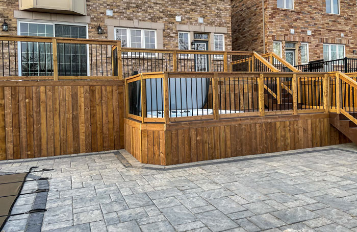 VanKuikConstruction-2024-large-two-tier-deck-interlock-stone A Van Kuik Construction backyard project with multi-tier deck, interlock patio, and pool.